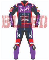 Front view of Miguel Oliveira’s MotoGP 2025 race suit in Yamaha Prima colors, detailed with Alpine, Pramac, and BLEED logos, and purple knee sliders on a dark blue and red base